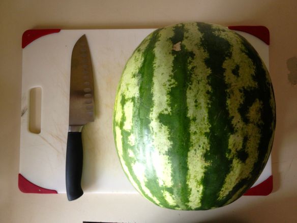 Watermelon and Santoku knife on cutting board
