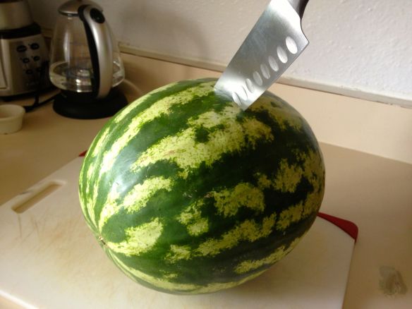 Watermelon being sliced in half